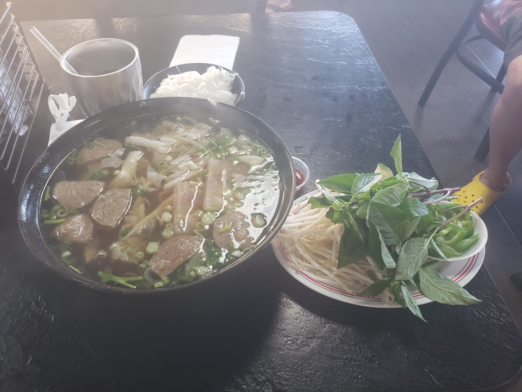 A bowl of pho with herbs at Pho 79 in Garden Grove, California